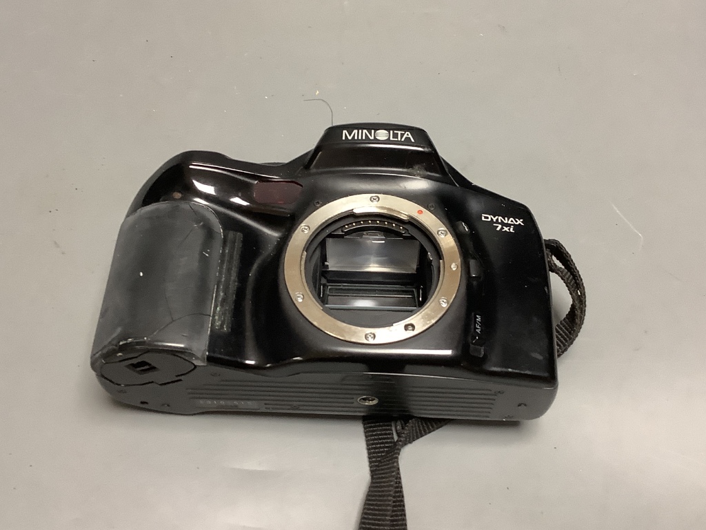 A Minolta Dynax digital camera body and a vintage kodak camera